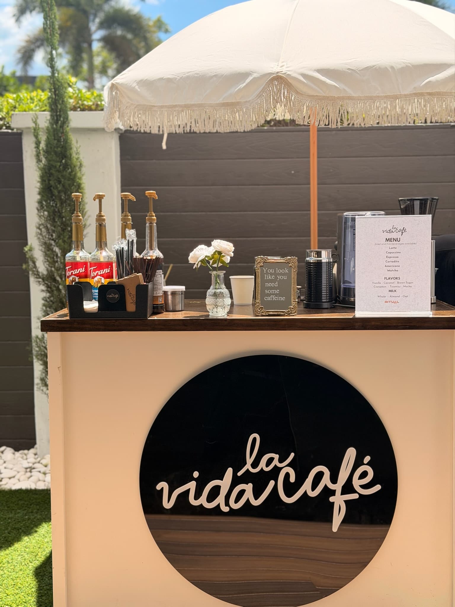 La Vida Café cart with white fringed umbrella